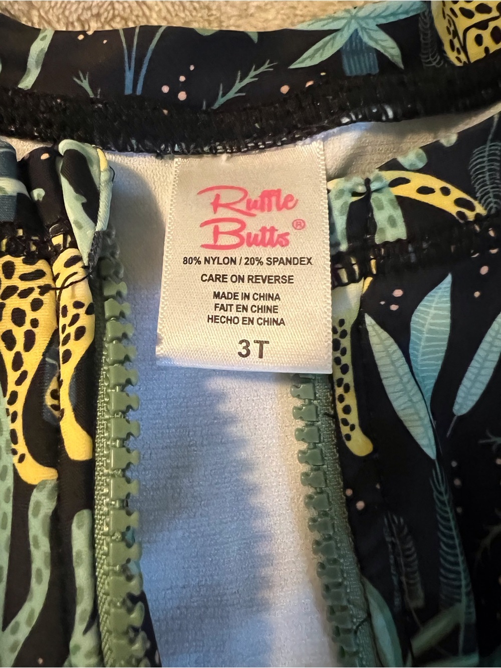 RuffleButts Black Tropical Zip front One-Piece with Yellow & Green Leaf Print